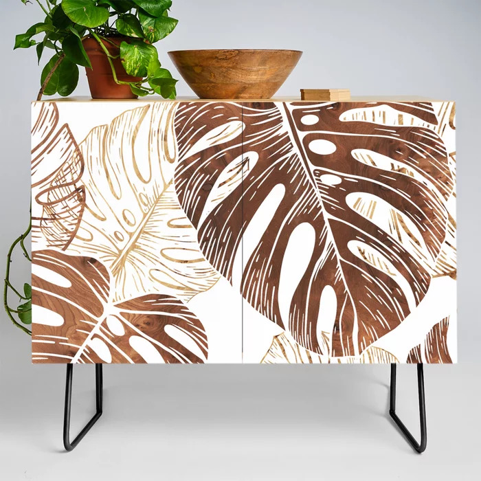 monstera in wood credenza